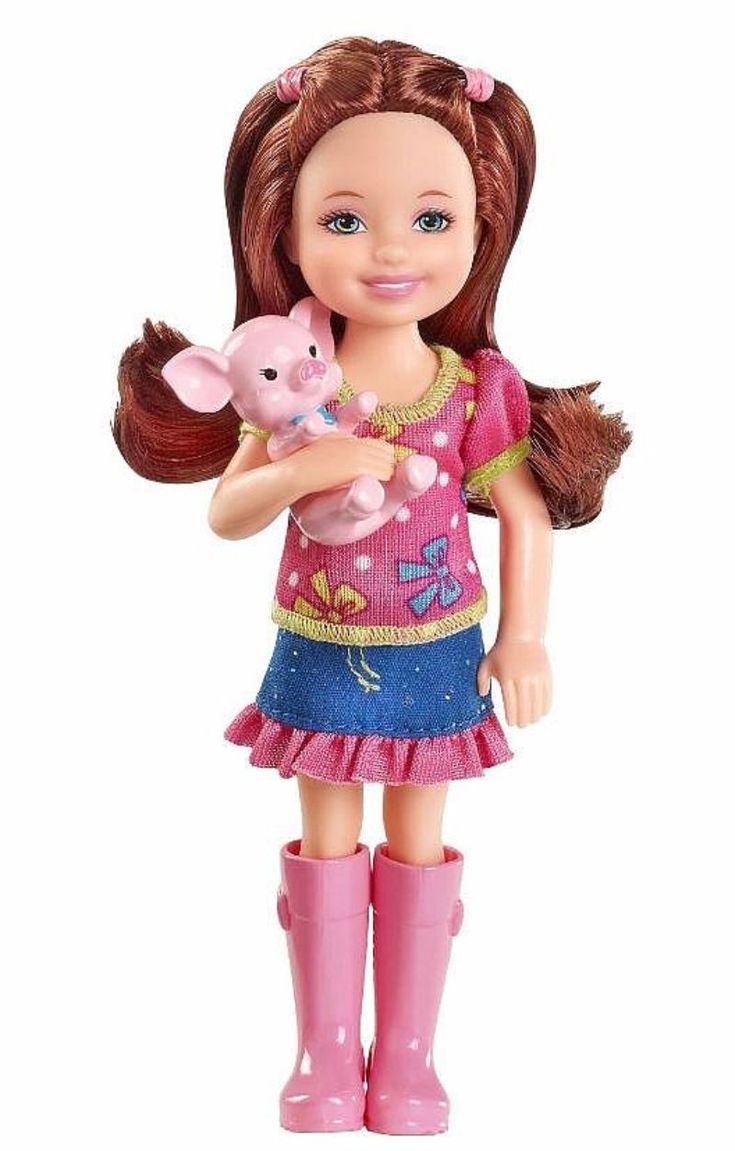 a doll holding a pink pig in her hands