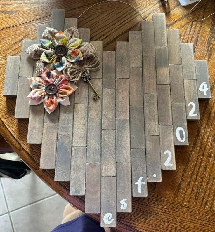 a wooden table with numbers on it and a flower pinned to the board that has been cut out