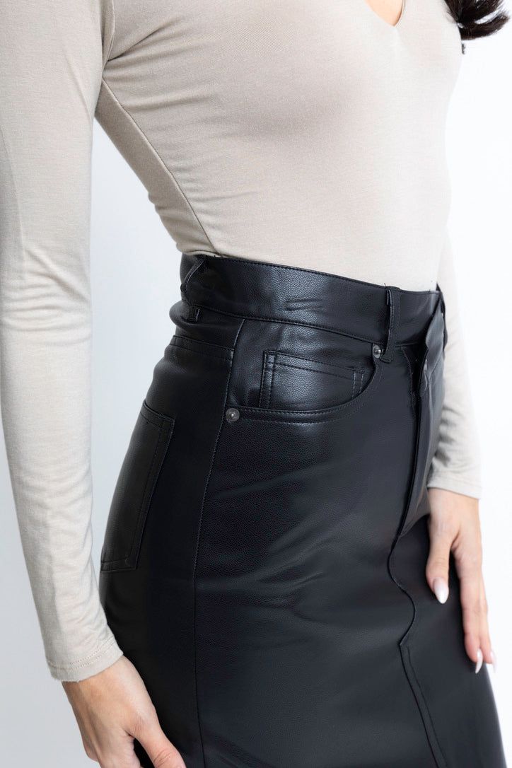 Our Pleather Cross Front Skirt is a stylish and fun addition to any wardrobe. Its cross front design and button detailing offer a unique and eye-catching look. With the added functionality of pockets, this skirt is not only fashionable but also practical. Elevate your outfit game with this must-have piece. Trendy Fitted Bottoms With Faux Front Pockets, Fall Mini Skirt With Pockets For Night Out, High Waist Leather Skirt For Work, Edgy Lined Skirt For Fall, Fall Mini Skirt Bottoms With Belt Loops, Leather Skirt Bottoms For Workwear, High Waist Mini Skirt With Pockets For Night Out, Chic High Waist Bottoms With Faux Front Pockets, Faux Leather Lined Skirt For Work