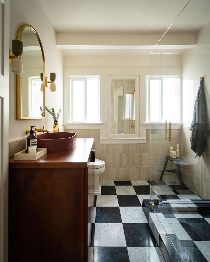 a bathroom with black and white checkered flooring