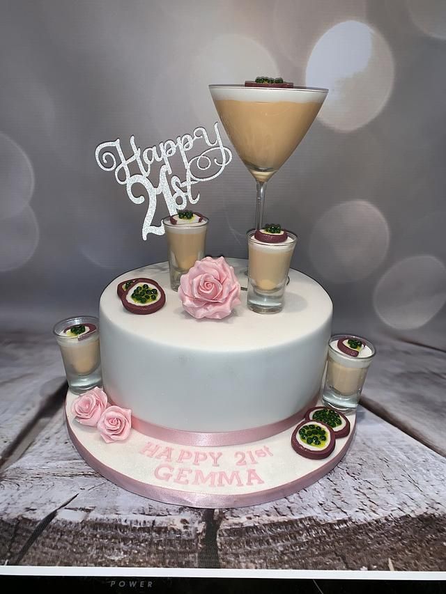 a white cake with pink flowers and glasses on top