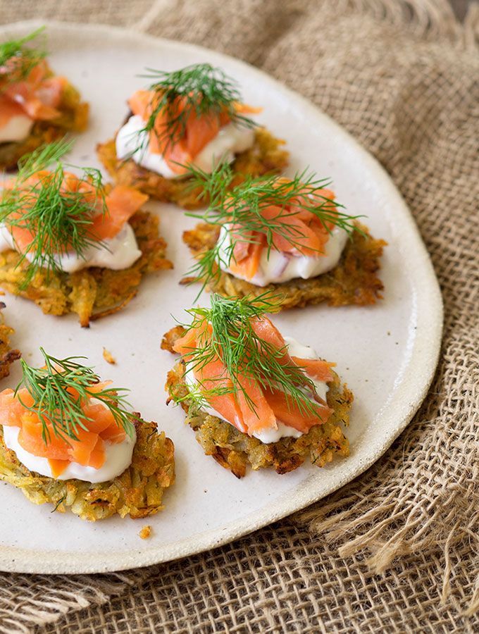 small appetizers are arranged on a plate with dill garnishes