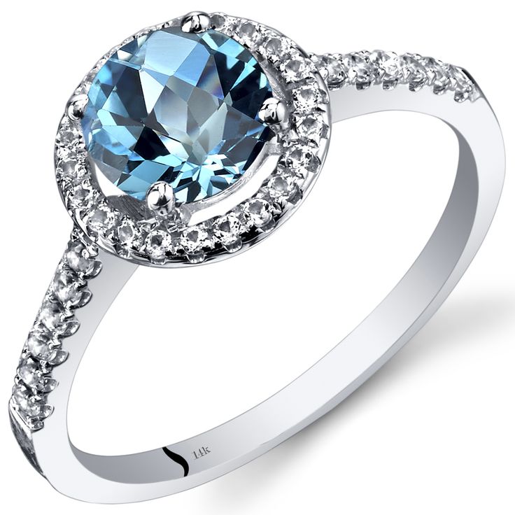 an oval blue topaz ring with diamonds around it