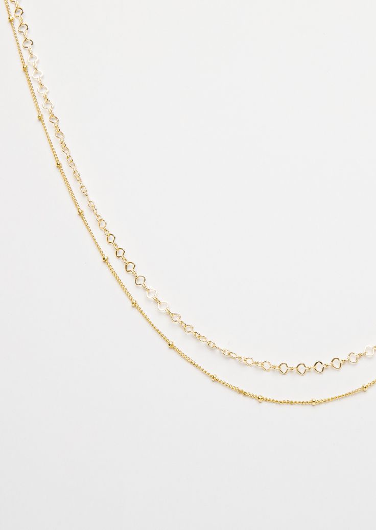 PRODUCT DETAILS Water Resistant💧 Brass 18K Gold Gold Filled Chain Hypoallergenic Nickel Free SIZE: 13" Short necklace + 14" Long necklace + 3" Extender. DESIGNER NOTE The Arrow Double Choker in gold metallic layering detail. Double up your choker collection with the two-in-one Necklace. The iconic detailing is the perfect fashion statement. STYLE TIP: That Smocked mini-Dress, The Arrow Double Choker and some Opal Rings will give you the perfect summer vibes. Gold Multi-strand Satellite Chain Necklace, Everyday Gold Choker Layered Necklace, Gold Double Strand Clavicle Chain Choker, Dainty Gold Multi-strand Chain Necklace, Gold Choker Necklace With Satellite Chain, Gold Layered Choker Necklace, Delicate Gold Choker Chain Necklace, Gold Double Strand Choker With Adjustable Chain, Double Strand Delicate Chain Choker For Layering