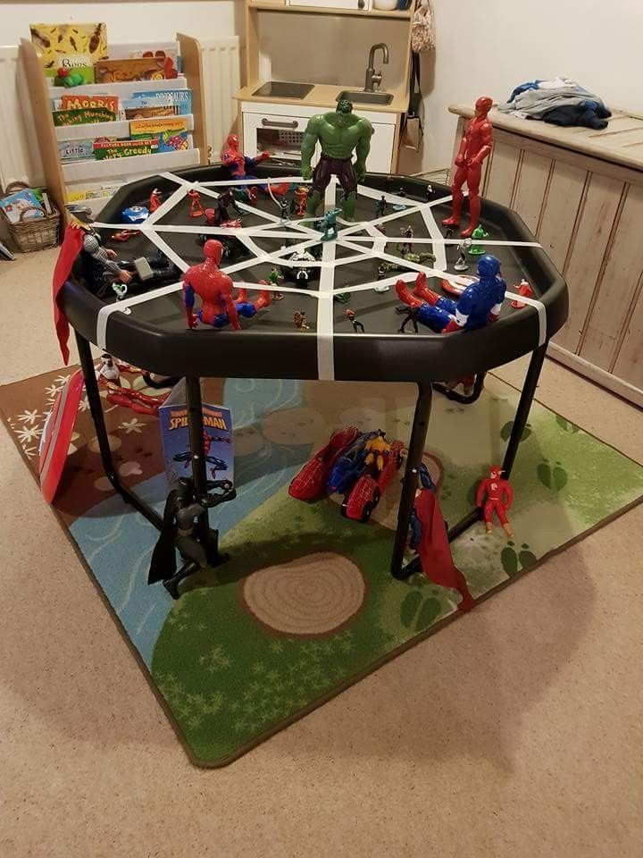 a play table with toy cars and people on it