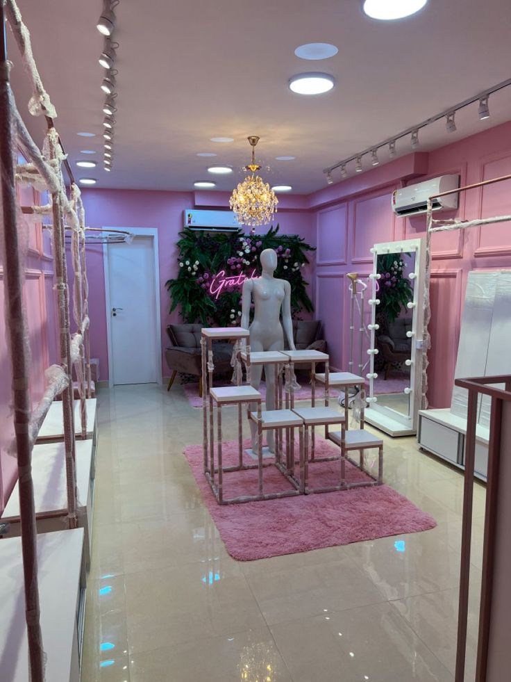 a room filled with lots of furniture and pink carpeted flooring next to a chandelier