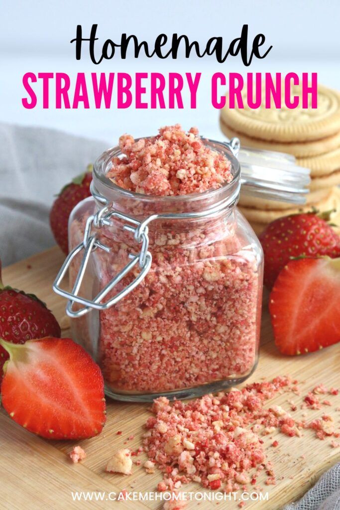 homemade strawberry crumbs in a glass jar on a cutting board with strawberries