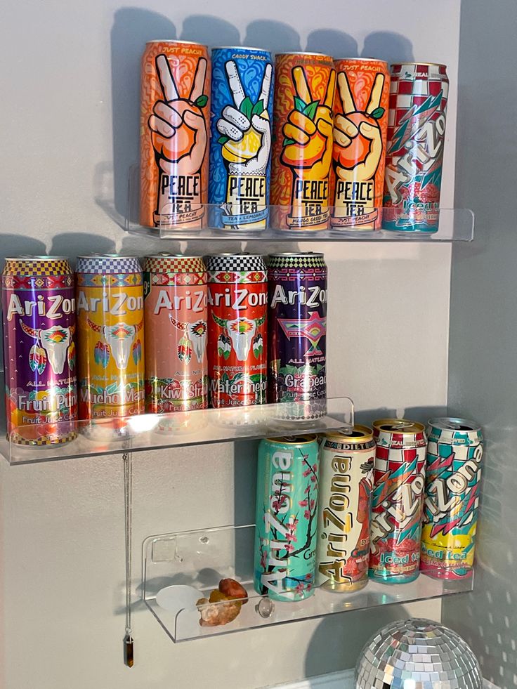 several cans of soda are on the shelf