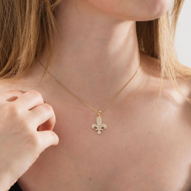 This Solid Gold Fleur de Lis Necklace is an excellent choice for a fine jewelry gift or something special for yourself! It will make an ideal Christmas, anniversary, or Valentine's Day present for her. This delicate gold necklace with a distinctive design looks excellent on its own or with other basic pieces of jewelry. Made of 10K and 14K solid gold. Details of the product Material: 10K and 14K Solid Gold Elegant Gift For people whom you love; Mom, Girlfriend, Wife, Fiance, Best Friend; Dainty Elegant 14k Stamped Flower Pendant Jewelry, Elegant 14k Stamped Flower Pendant Necklace, Elegant 14k Gold Flower Pendant Necklace, Exquisite 14k Stamped Jewelry Gift, Exquisite 14k Stamped White Gold Jewelry, Fine Jewelry Flower Pendant Tarnish Resistant, Fine Jewelry With Tarnish Resistant Flower Pendant, Engraved Yellow Gold Cubic Zirconia Necklace, Elegant 14k Gold Hallmarked Charm Necklace