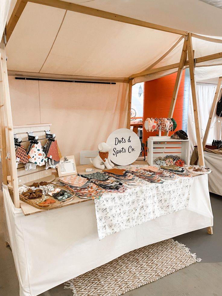 a table covered in lots of different types of food on it's sides and under a tent