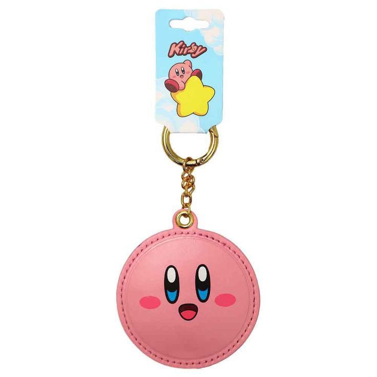 a pink key chain with an emoticive face on it's front and back