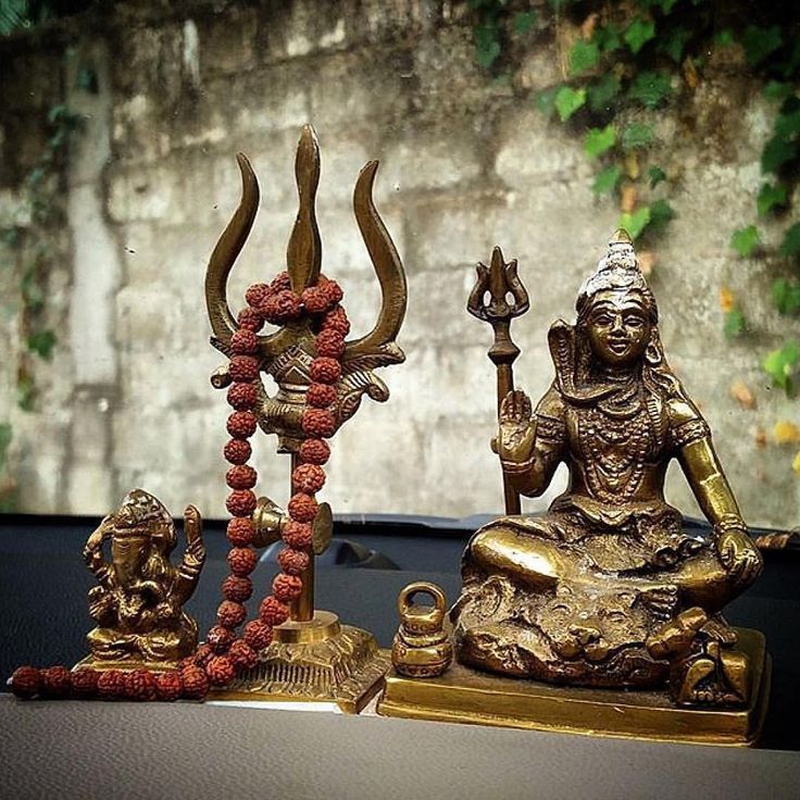 two statues sitting on top of a table next to each other