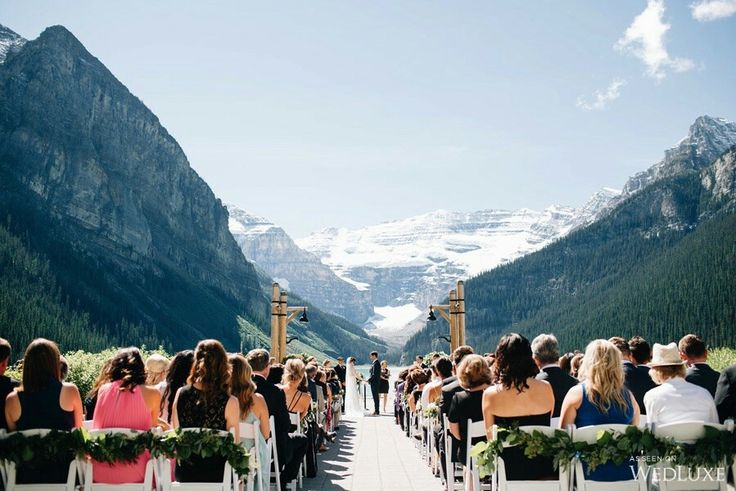 a group of people that are sitting in chairs on the side of a mountain road