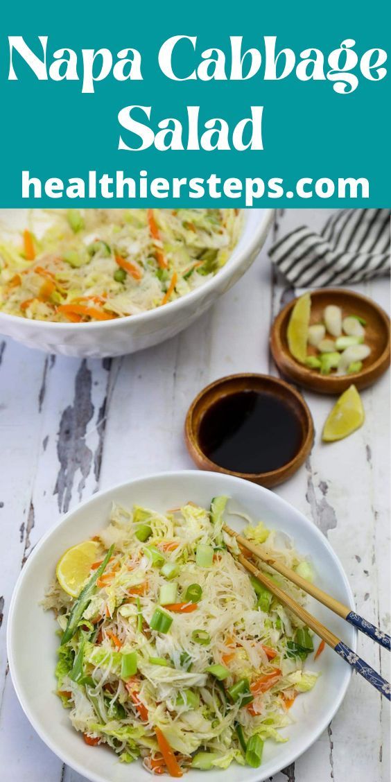 two white bowls filled with cabbage salad and chopsticks next to some dipping sauce