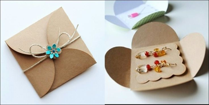 an open heart shaped box next to a small card with earring clips in it