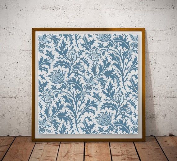 a blue and white wall with a wooden frame on the floor in front of it