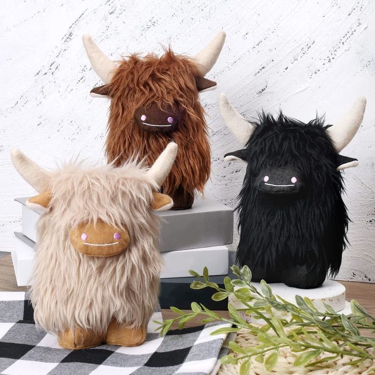 three stuffed animals sitting on top of a table