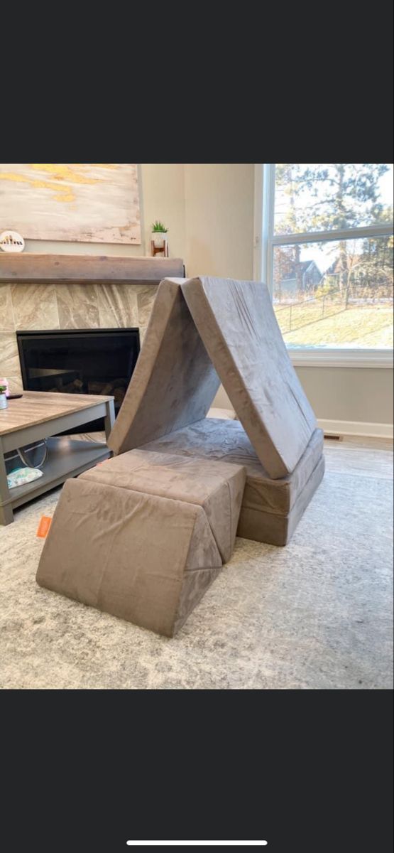 a couch made out of cardboard sitting on the floor