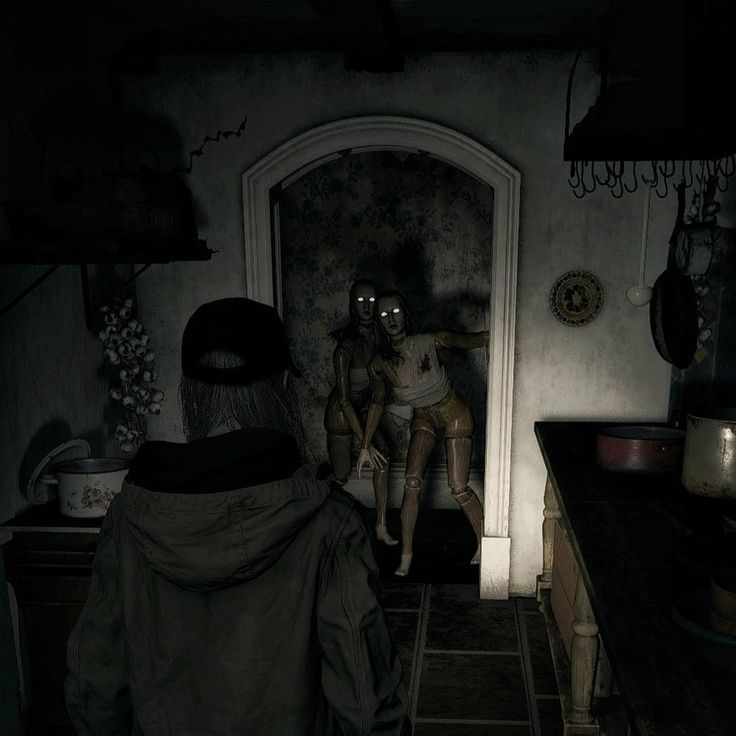 two people standing in a dark kitchen with one holding the door open to another person