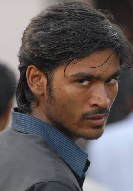 a close up of a person wearing a shirt and tie with hair in the wind