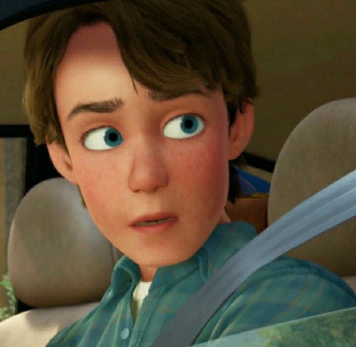 a young boy with blue eyes sitting in a car