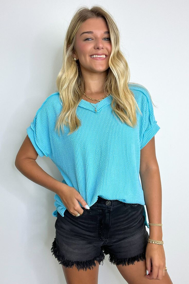 Details: Get ready to relax in style with the Maribeth Rib Knit Short Sleeve Top. This solid twist rib top features a flattering v neckline, short sleeves, and side slits for a relaxed fit. Perfect for any casual occasion, this top is the epitome of comfort and style. - Rib knit - V-neck Content: 77% POLYESTER 17% RAYON 6% SPANDEX Size + Fit: Model is 5'8" and wearing a Small - Measurements from a size small - Full length: 24.5"(Front) 27"(Back) - Chest: 44" - Waist: 42" - Sleeves: 7" Brand: 7th Knit Short Sleeve Top, Rib Top, Cute Preppy Outfits, Knit Short, Crop Top Sweater, Crop Top Blouse, Back In Stock, Knit Shorts, Dress With Cardigan