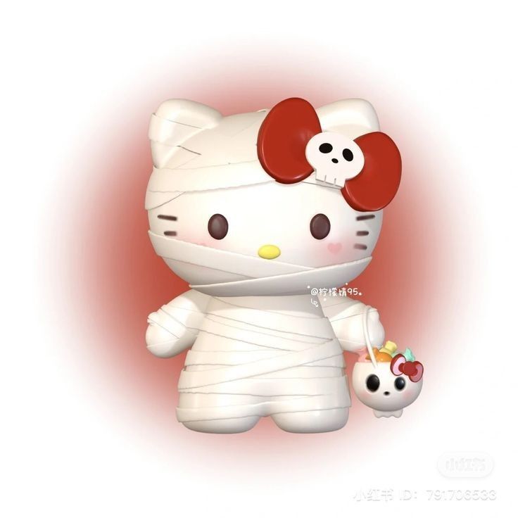 a hello kitty doll holding a strawberry in her hand