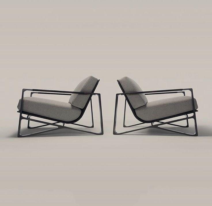 two modern lounge chairs sitting side by side on a white background, one in grey fabric and the other in black metal