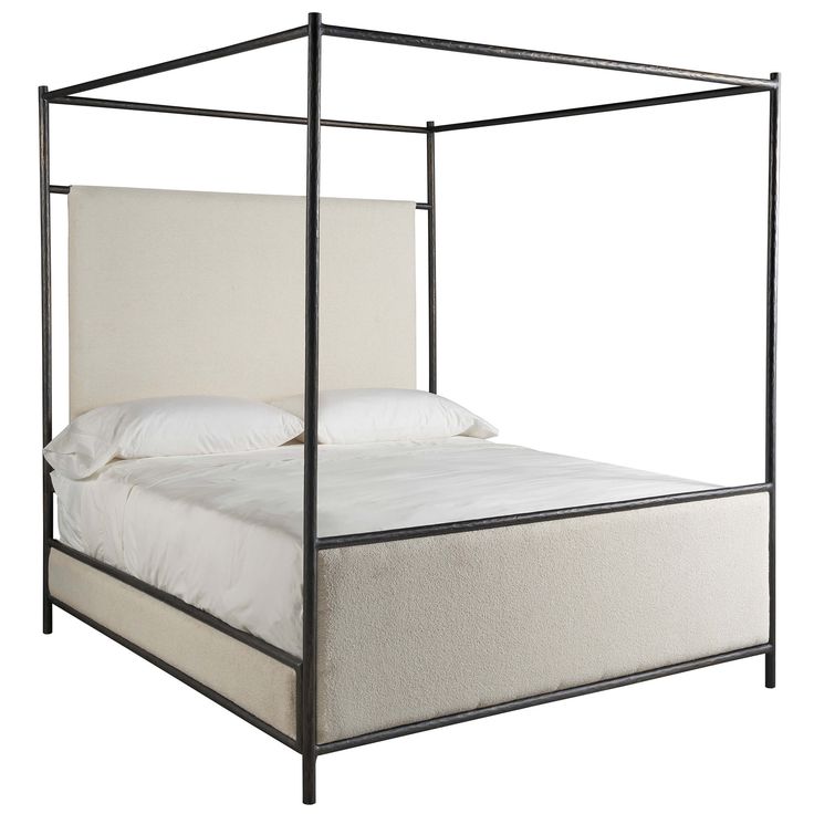 an iron bed frame with white linens and pillows on the bottom, against a white background