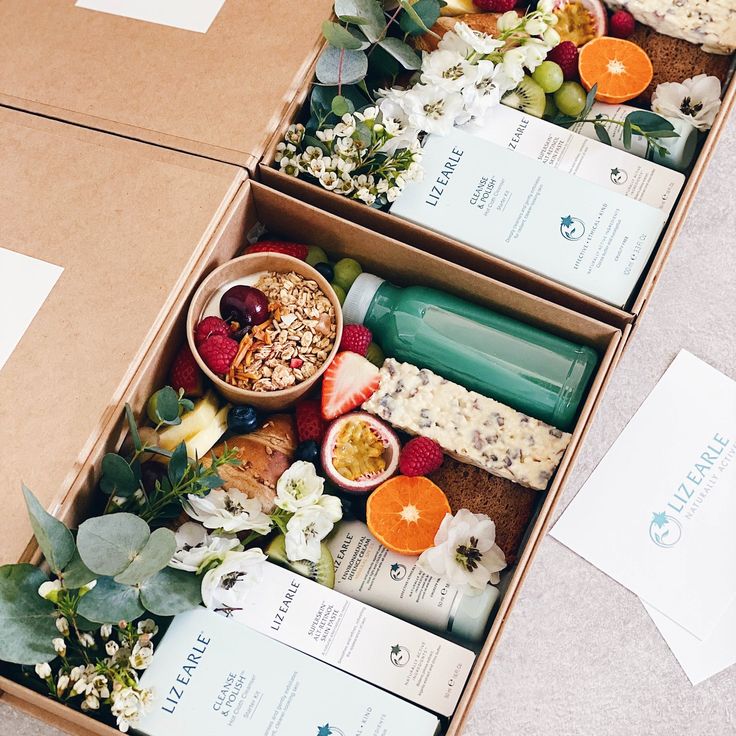 three boxes filled with different types of food on top of a floor next to each other