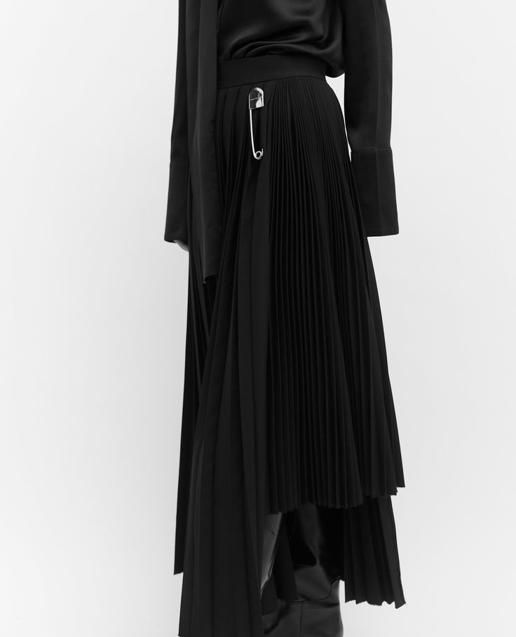 Our black contrast pleated skirt is made of 100% wool, woven in Yorkshire at the mill Alfred Brown. The skirt is hand pleated in London. The skirt features two contrast pleats and a side entry invisible zip and our signature oversized branded safety pin. The Mill, Single Breasted Jacket, Invisible Zip, Safety Pin, Black Wool, Pleated Skirt, Yorkshire, Fabric Care, Design Details