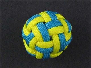 a yellow and blue ball on a black surface