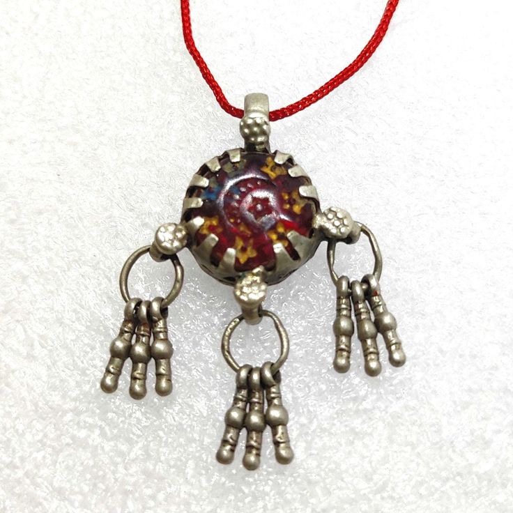 Handmade Vintage Rare Real Old High Grade Silver Small Dangles Ethnic Tribal Charm Banjara Traditional Red Stone Bell Pendant Necklace With Colour String.... Made By someone else. Discovered and collect by me from a small tribal banjara village of Rajasthan. Primary Color of Necklace is Vintage Silver, Pre- Owned, Old looks. Necklace Weight 6.9 gms. Length of Pendant With Dangles 4. cm Width of Pendant 2.8cm. It's a totally Handmade vintage tribal Silver Pendant from Rajasthan state Northern India. Your Feedback is very Important for us so leave positive Feedback. If you have any Problem or you are not satisfied with our product so Please Contact us before leaving negative Feedback. We also Believe is Customer Satisfaction. Thread Necklace, Bell Pendant, Red Stone, Primary Color, Vintage Silver, High Grade, Silver Fashion, Silver Pendant, Hippie Boho