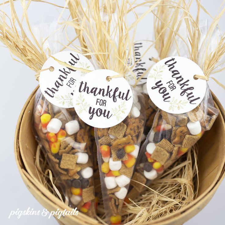 some kind of candy bar in a basket with thank you tags on it's top