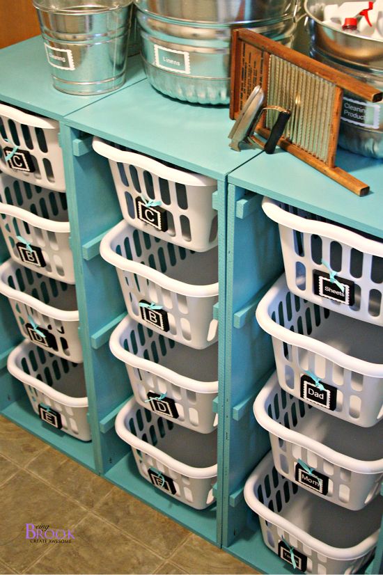 several plastic bins are stacked on top of each other in front of a blue cabinet