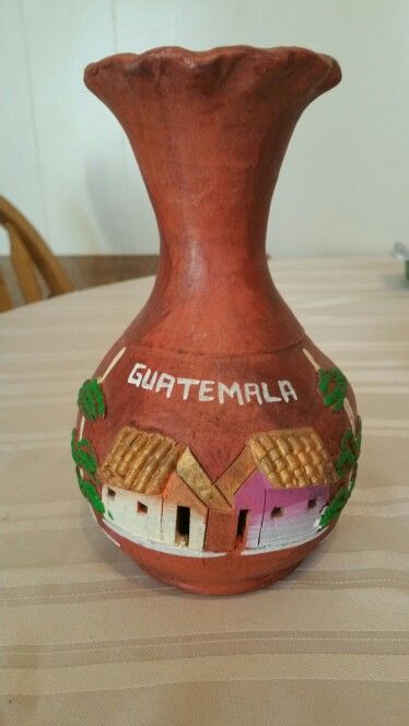 a ceramic vase with the word guatemala painted on it's side sitting on a table