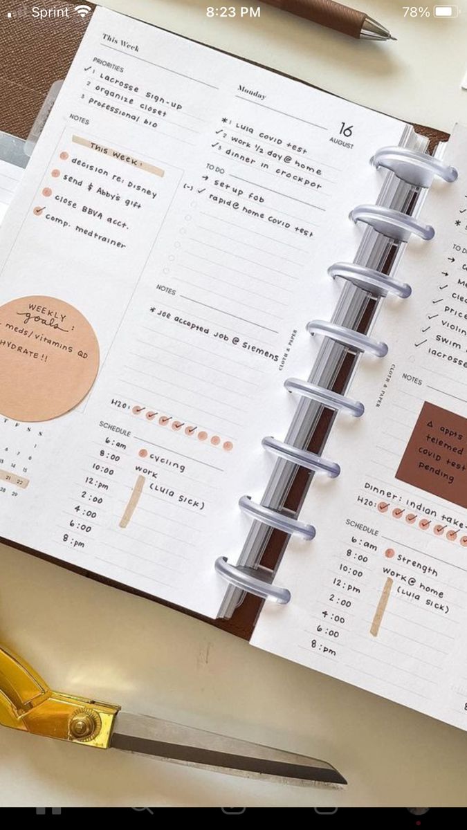 an open planner book sitting on top of a desk