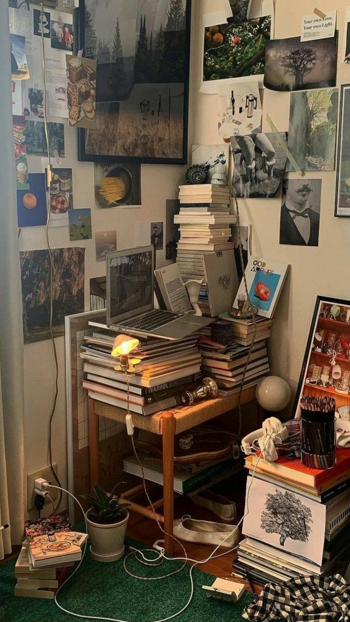 a room filled with lots of clutter and pictures on the wall next to a window