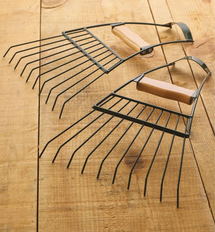 a wooden table topped with metal items on it's sides and a wire rack in the middle