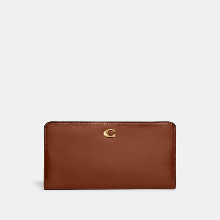 Crafted of refined leather detailed with our Signature hardware the perfectly named Skinny Wallet organizes essentials in a slender silhouette. The snap closure opens to reveal 15 card slots multiple full-length bill compartments a zippered coin pocket and a convenient ID window. | Coach Skinny Wallet - Women's - Brass/1941 Saddle Organization Essentials, Large Wallet, Signature Hardware, Wallet Organization, Slim Wallet, Small Wallet, Wallets For Women, Snap Closure, Card Slots