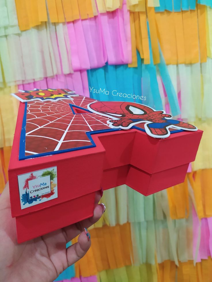 someone is holding up a box that looks like a spiderman