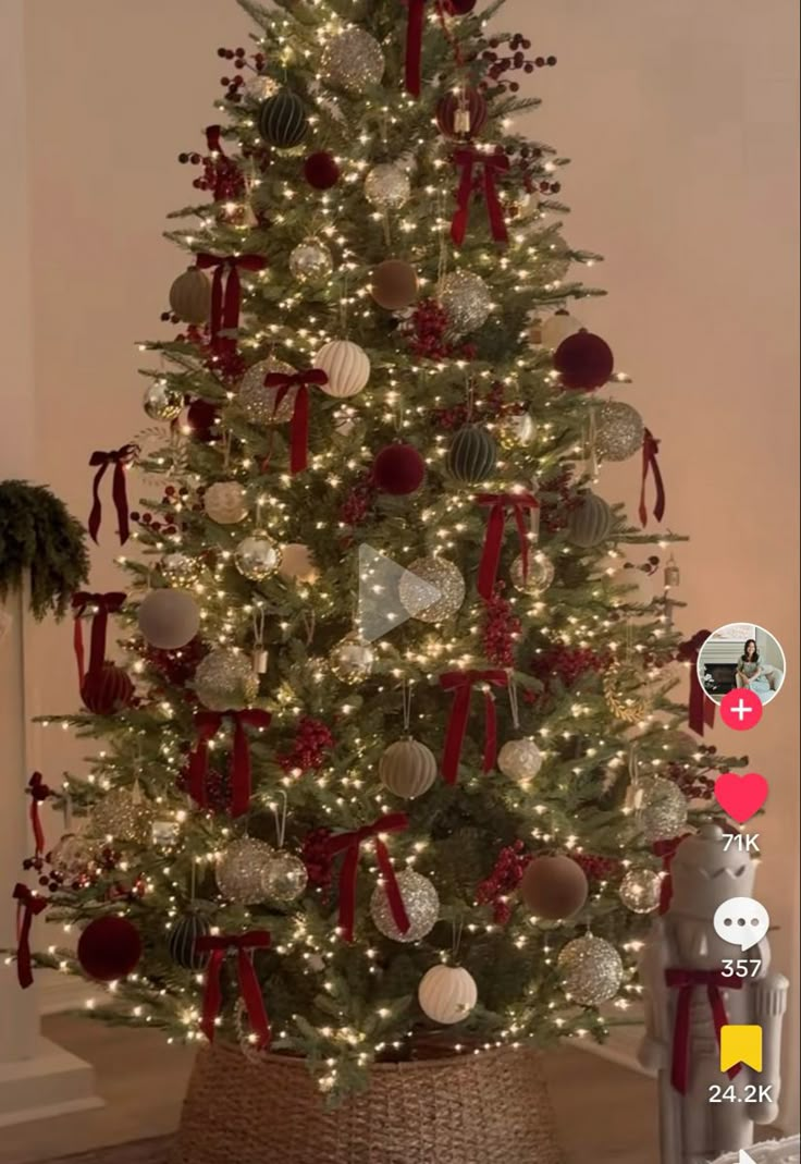 a white christmas tree with red and silver ornaments