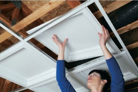 a woman reaching up to the ceiling with her hands