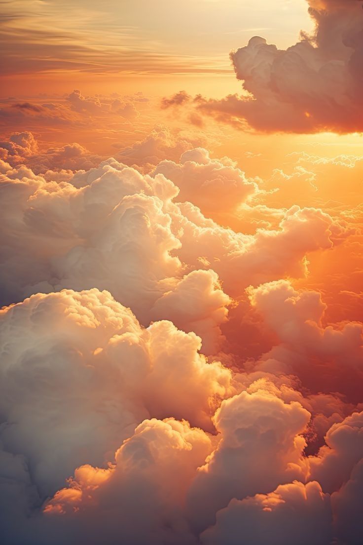 the sky is filled with fluffy clouds as the sun sets over the horizon behind it