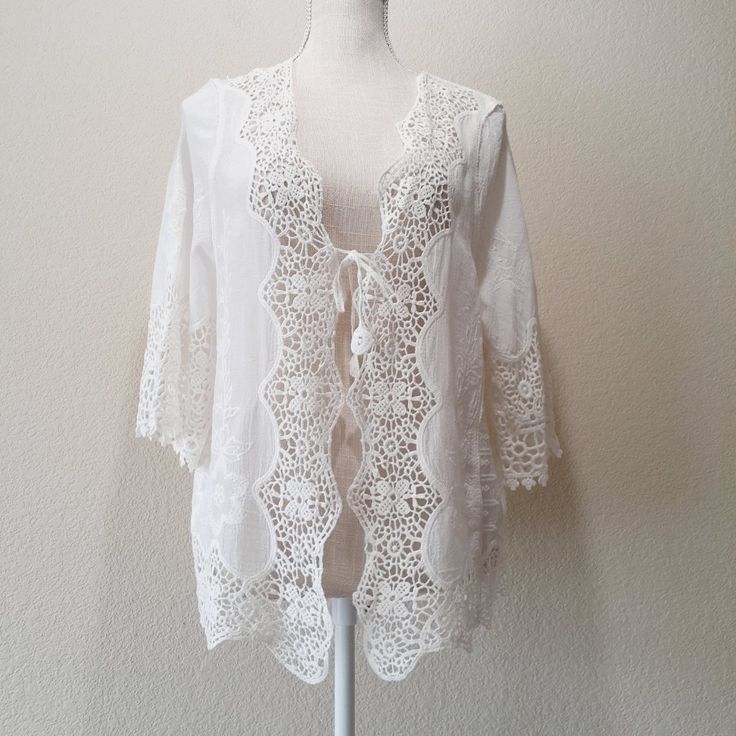 Creamy White Cotton Gauze With Embroidered Design Crochet Lace Trim All Around Crochet Cut-Out Design In Back Tassel End Ties In Front Note: This Item Is New With Tags But There Are No Interior Tags/Labels Such A Pretty Topper! Excellent Condition, New With Tags Size: "One Size" Approx." 21' Pit-To-Pit / 21' Across The Middle /24' Length White Crochet Lace Top For Brunch, Embroidered Lace V-neck Top, Lace Blouse With Crochet Trim For Brunch, Fitted Lace Cover-up With Lace Trim, Spring Beach Cover-up Tops With Lace Trim, Embroidered Bohemian Lace Top For Summer, Bohemian Embroidered Lace Top For Spring, White Lace Top With Crochet Trim, White Lace Top With Crochet Trim For Daywear