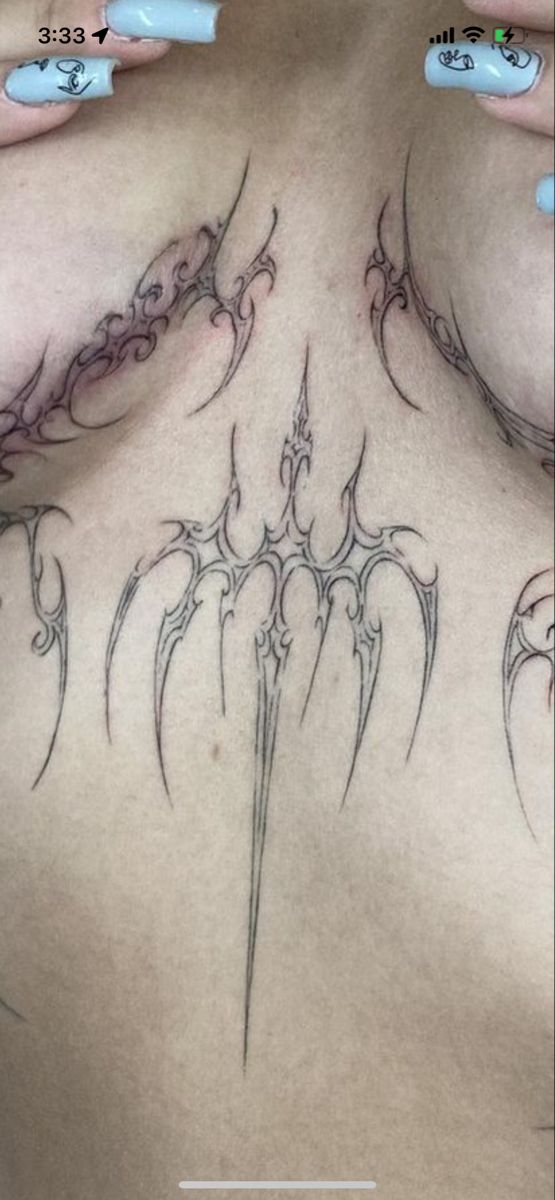 a woman's chest with some tattoos on it