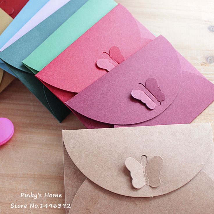 several different colored envelopes with paper cutouts on them