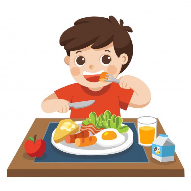 a boy is sitting at the table with breakfast