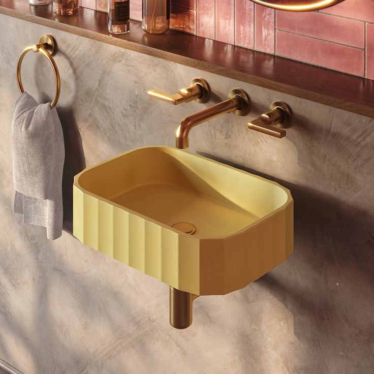 a bathroom sink sitting next to a wall mounted faucet and towel rack in front of a mirror