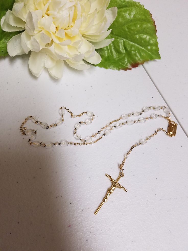 "Beautiful Vintage Rosary, new never been used in original clear box. Makes a perfect gift for Catholic Wedding couple, First Communion, Confirmation, Birthday. Dementions: Decades length: 18\" Complete folded rosary as shown laying on table including crucifix: 14\" Crucifix: 1 1/2\" x 7/8\" FINAL SALE, NO RETURNS, NO EXCHANGES, PLEASE CONTACT FOR ANY QUESTIONS OR CONCERNS AFTER LOOKING AT ALL THE PICTURES." Gold Rosary With Round Beads As Gift, Gold Round Beads Rosary As Gift, First Communion Spiritual Rosary With Crucifix, Spiritual Rosary With Crucifix For First Communion, Spiritual Crucifix Rosary For First Communion, First Communion Rosary With Miraculous Medal, Spiritual Crucifix Rosary As Gift, Spiritual Cross Rosary For Confirmation, Adjustable Gold Rosary For First Communion